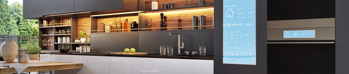 A modern kitchen with wood and dark cabinets, featuring a vertical smart screen displaying home control settings